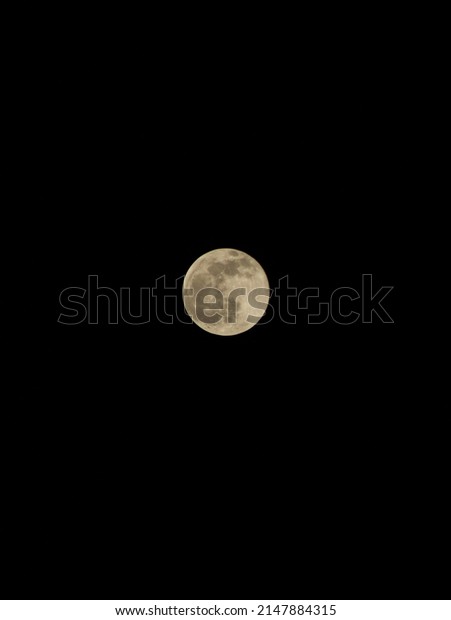 Black\
background and in the middle there is a full\
moon