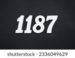 Black for the background. The number 1187 is made of white painted wood.