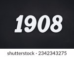 Black for the background. The number 1908 is made of white painted wood.