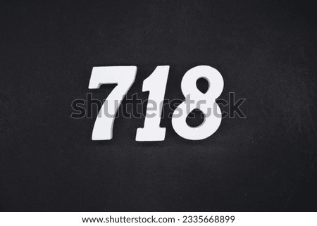 Black for the background. The number 718 is made of white painted wood.