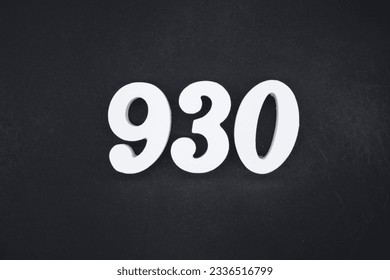 Black for the background. The number 930 is made of white painted wood.