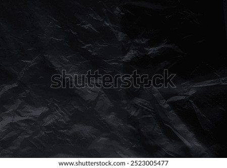 Black background plastic wrinkle bag film glossy crumpled overlay package rough wrap material pack reflection texture floor packaging retail grain pollution trash polyethylene, halloween backdrop.