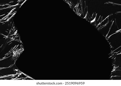Black background, ripped plastic frame. Plain dark black background, simple desktop background with plastic texture. Cool pitch black wallpaper background. Plastic sheet overlay on black backdrop.