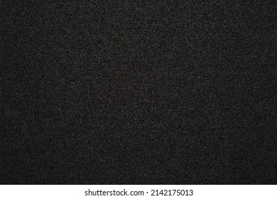 Black background with a rubber or asphalt texture. - Shutterstock ID 2142175013