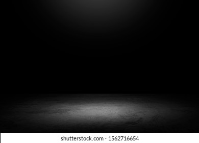 Black Background With Spotlight To Concrete Ground In Studio. Dark Interior Background. Room With Tile Or Cement And Concrete Floor.
