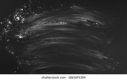 Black background sprinkled with flour, smeared flour, table for cooking, rolling dough. Blank space for menu text, recipe, ingredients. Chalk board and rubbed stains. - Shutterstock ID 1865691304