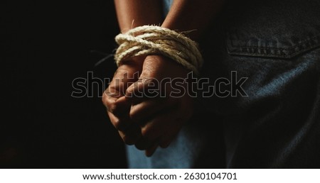 Black background, studio and hands of person with rope for prisoner, hostage and victim. Bondage, mockup space and closeup for human trafficking, domestic violence and crime for slavery or trauma