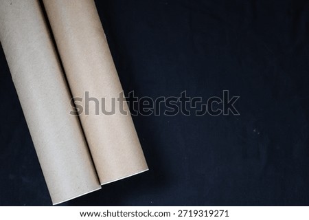 Black Background With Two Postal Tubes