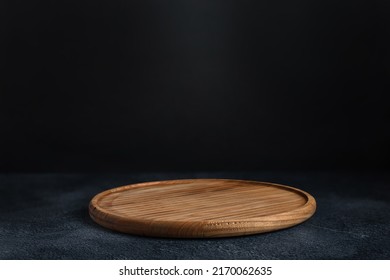Black background with wooden pizza board - Shutterstock ID 2170062635