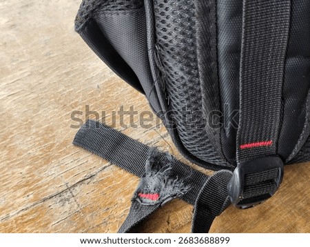 Black backpack with broken strap