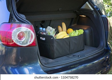 Black Bag Basket Full Of Products In The Car Trunk