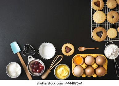 Black Bakery Text Space Images With Baking Utensils And Recipe Ingredient. Frame Border Formed By Baking Utensil And Baking Ingredient. Overhead View Text Space Image.