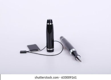 Black ballpoint pen with a cap