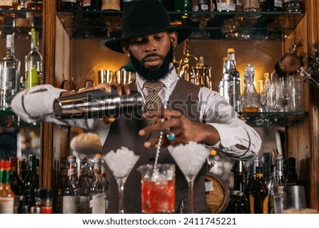 Similar – Image, Stock Photo Stylish black bartender preparing a cocktail with a smoke bubble in a traditional cocktail bar