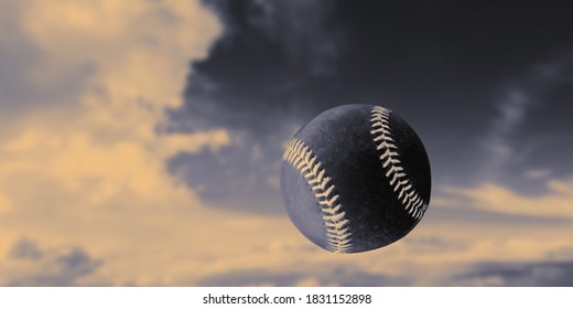 Black Baseball Ball In The Air. Close-up. Blurred Sky Background