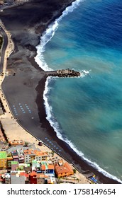 Black Beach With Blue Lounge Chairs On The Island Of La Palma