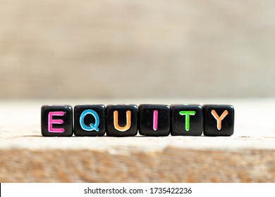 Black Bead With Color Letter In Word Equity On Wood Background