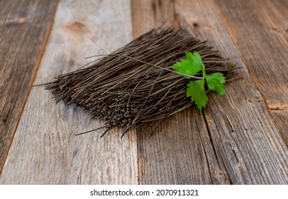 Black Bean Pasta Raw And Uncooked On Wooden Table With Copy Space