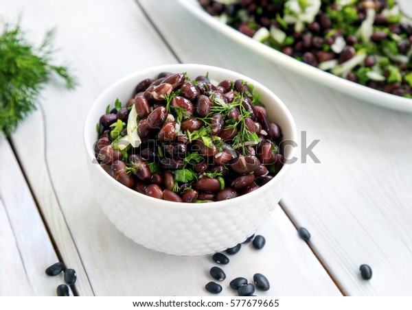 Black bean salad on white\
background.