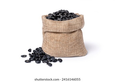 Black bean (Urad dal, black gram, vigna mungo) in hemp sack bag isolated on white background.