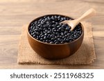 Black bean in wooden bowl with scoop, Food ingredient