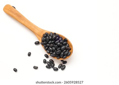 Black beans in spoon, top view of black bean in spoon on white background, isolate of beans, black bean with spoon isolated on white 