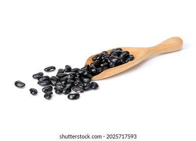 Black beans (Urad dal, black gram, vigna mungo bean) in wooden scoop isolated on white background. 
