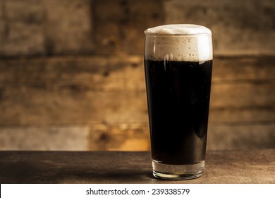 Black beer on wooden background