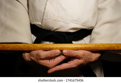 Black Belt Martial Arts Teacher holding  a wooden staff - Powered by Shutterstock