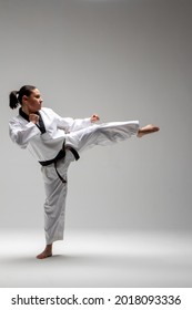 Black Belt Woman Taekwondo Side Kick, Young Black Belt Woman In Karate Giving Side Kick