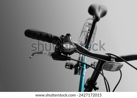 Black bicycle handlebar. Close-up. Isolated on a gray background.