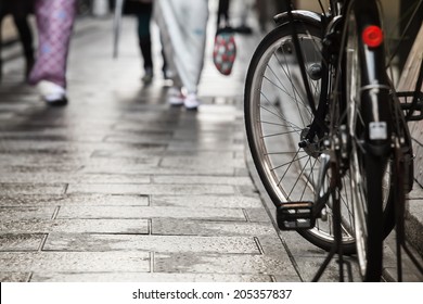 Black bicycle parking at a small japanese street/Bicycle Walkway - Powered by Shutterstock