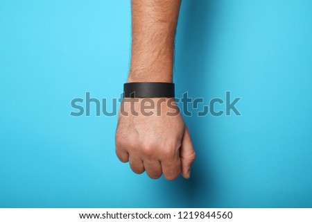 Black blank bracelet on hand. Music festival branding wristband, adhesive paper accessory for concert, event. mockup.