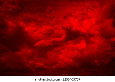Black blood red fiery sky with clouds. Horror background for design. Dramatic frightening ominous skies. Hell inferno. Scary, creepy, evil, spooky, eerie. Armageddon apocalypse concept.