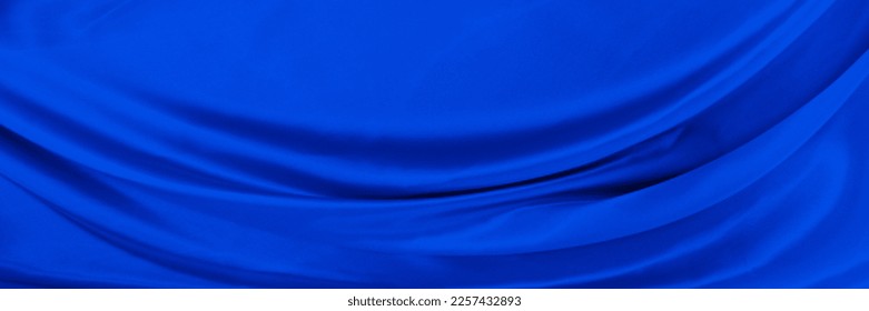 Black blue satin dark fabric texture luxurious shiny that is abstract silk cloth background with patterns soft waves blur beautiful. - Shutterstock ID 2257432893