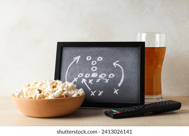 Black board with game strategy and a bowl of popcorn - Powered by Shutterstock