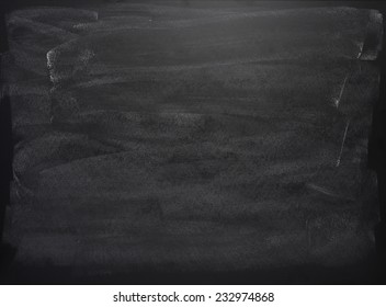 Black Board With The Traces Of Chalk Over Its Surface As A Background Texture