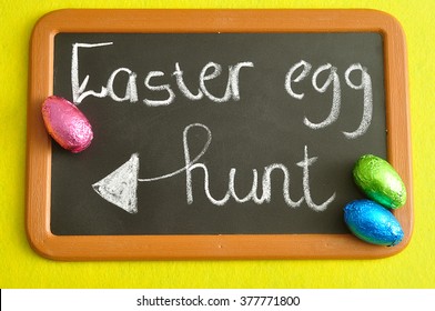 A Black Board With The Word Eater Egg Hunt Written On It Displayed With Colorful Easter Eggs