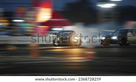 Black body racing sport cars moving slipped on asphalt track with smoke and dark night light speed motion blur.