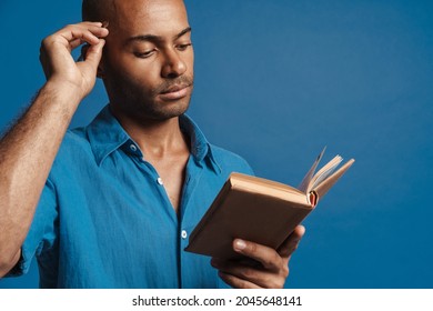 Black Bold Man Wearing Shirt Writing Down Notes In Planner Isolated Over Blue Background