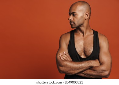 Black Bold Man Wearing Shirt Posing With Arms Crossed Isolated Over Brown Background