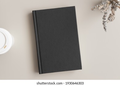 Black Book Mockup With A Lavender And A Coffee Paper Cup On A Beige Table.