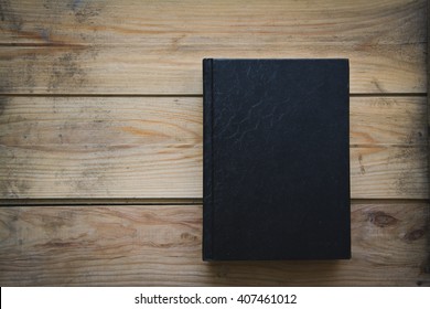 Black Book On A Wooden Table