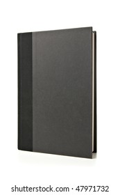 Black Book Standing Up On White Background. Studio Lit And Isolated.