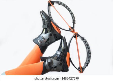 Black boots for jumping on a white  background. Kangoo jumping shoes for fitness with orange accents on a white  background.