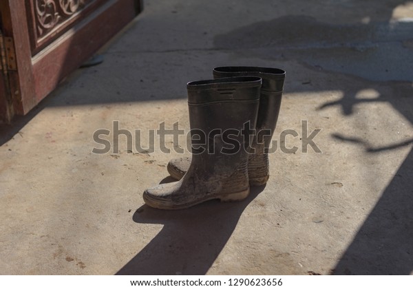 Black Boots Stained Mud On Cement Stock Photo Edit Now