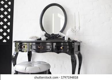 Black Boudoir Table In A Bright Room With A White Brick Wall.