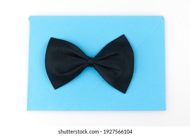 Black Bow Tie With Blank Invitation On White Background