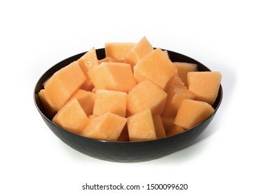 A Black Bowl Of Cubed Cantaloupe Melon Isolated On White