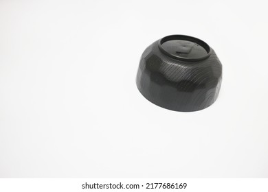 A Black Bowl Made Of Plastic Is Upside Down.